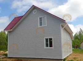КД35. Полутораэтажный каркасный дом 8х8 с террасой и эркером. Фото